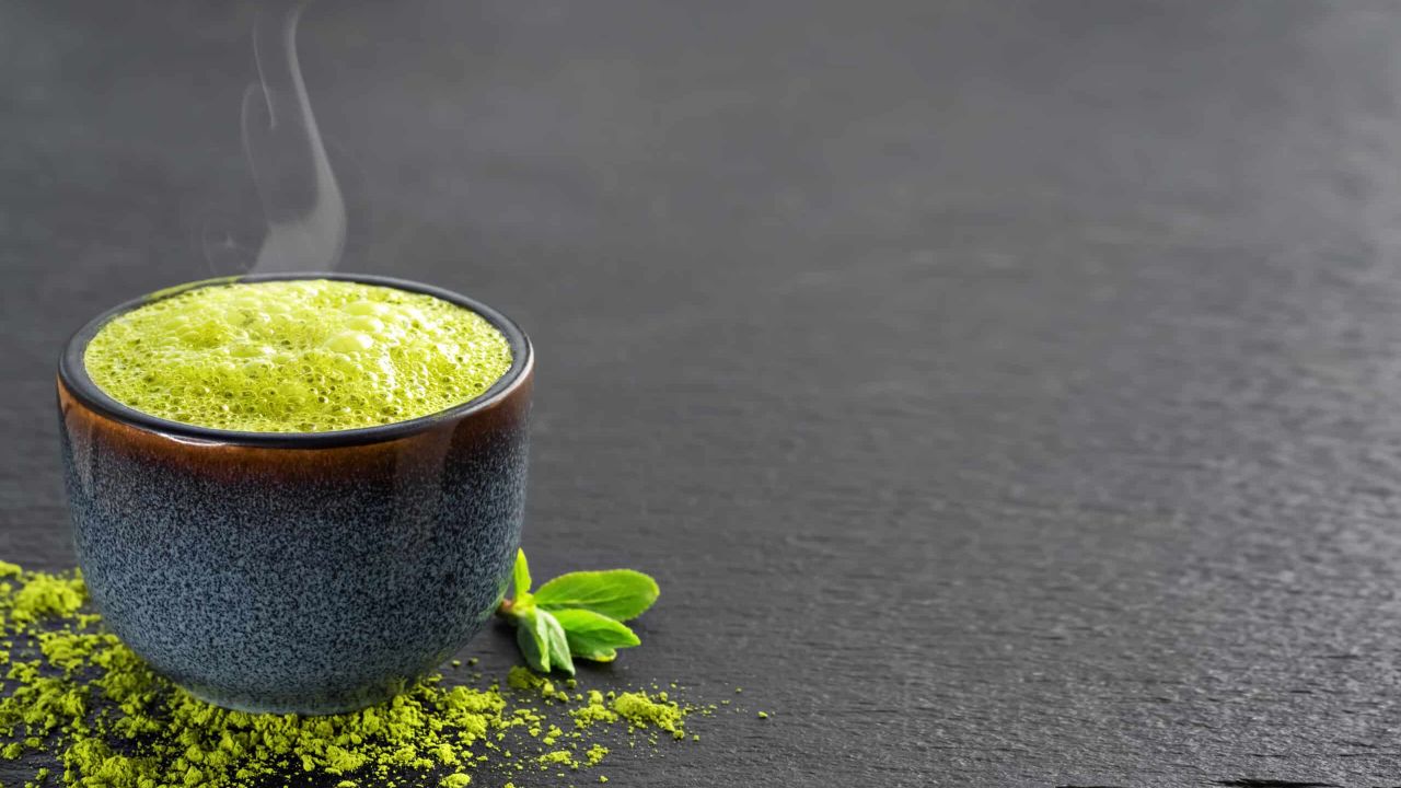 bowl blue with matcha green tea it are tea leaves tea powder table scaled 217af8b2