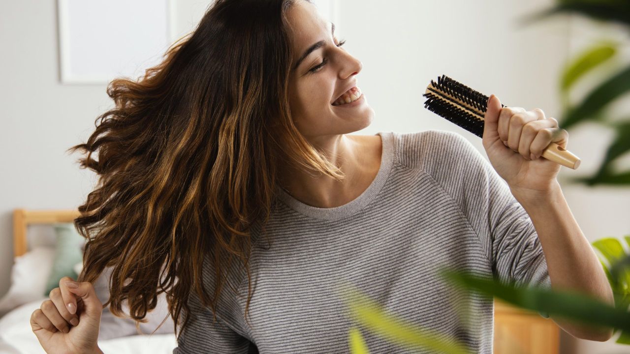 happy woman singing into hairbrush home scaled 3cce63a4