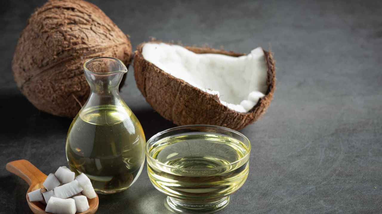 jug coconut oil whit coconut put dark background scaled 85530e6b
