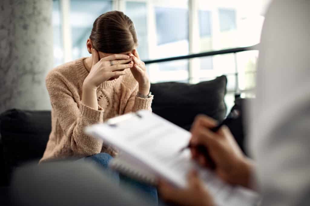 mulher deprimida tendo sessao de psicoterapia no consultorio medico