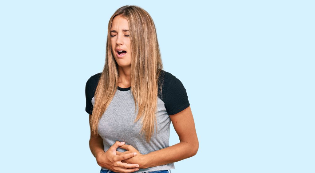 young blonde woman wearing casual clothes with hand stomach because nausea painful disease feeling unwell ache concept